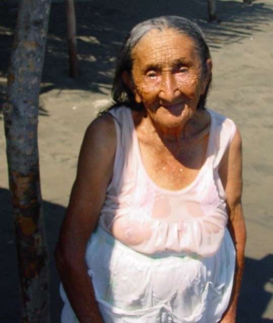 Old woman on the beach in Cuco