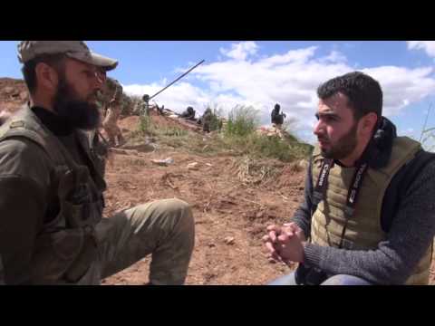 Youtube: سير المعارك في معسكر القرميد بإدلب.. لقاء مع قيادي في جيش الفتح من أعلى تل إسفن المحرر