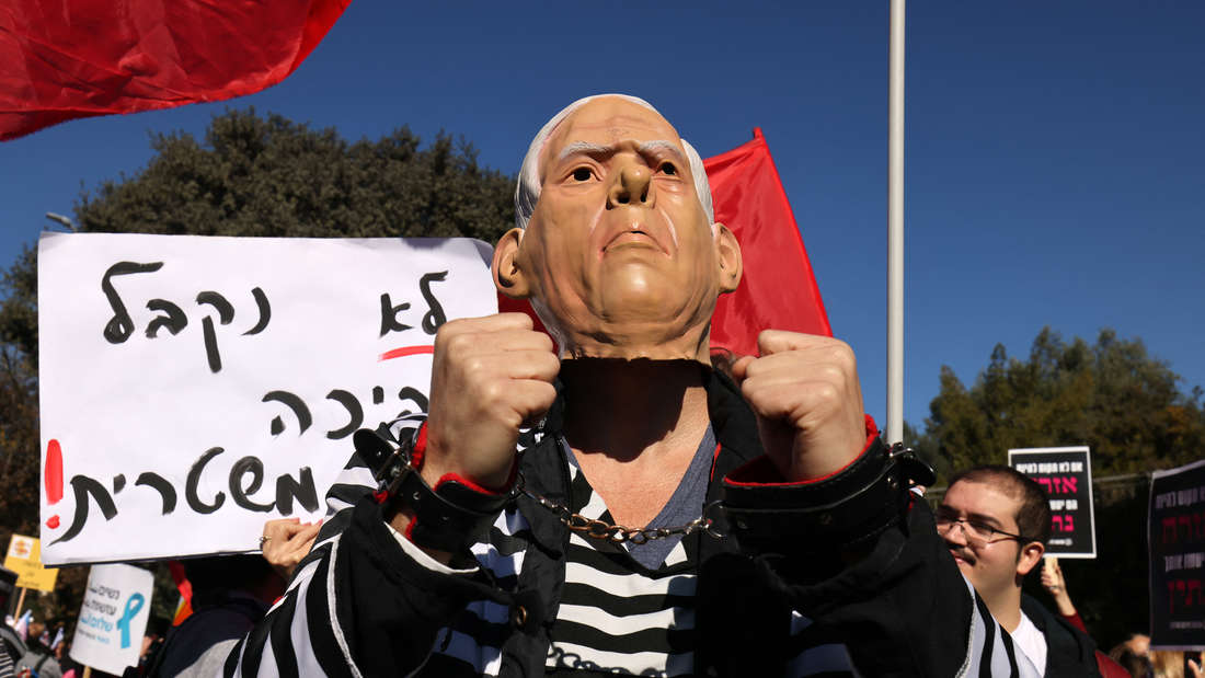 30583668-an-israeli-activist-wears-mask-
