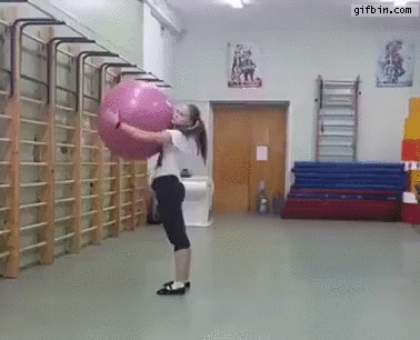 girl does backflips with exercise ball.g