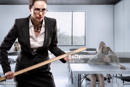 160384496 teacher posing with a ruler in