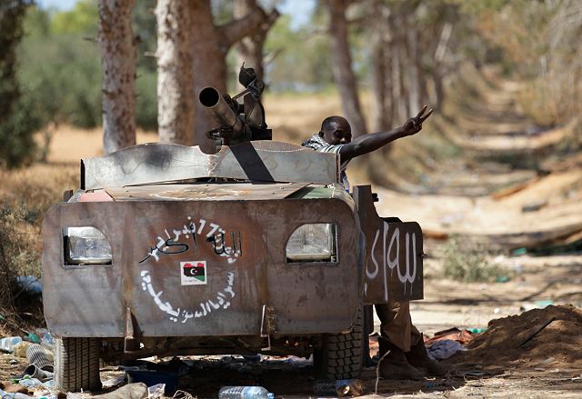 Libyan rebel fighter in a vehicle rigged