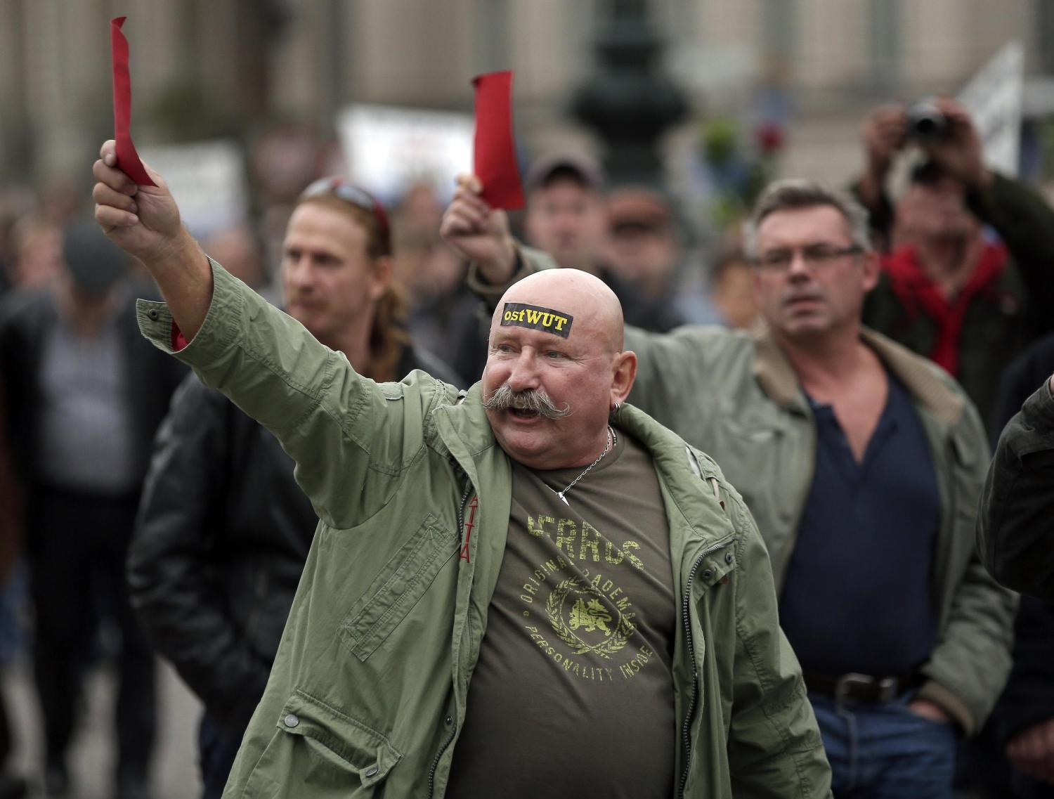 demonstrators hold red cards during a p.