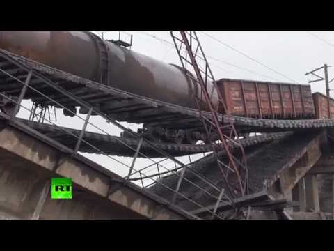 Youtube: RAW: Train suspended over motorway as bridge blown up in E. Ukraine