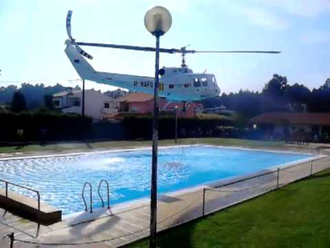 Youtube: Helicopter refills its water bucket from a public swimming pool