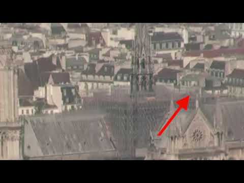 Youtube: Notre Dame fire 2019-04-15 - Person moving and flash on the roof?
