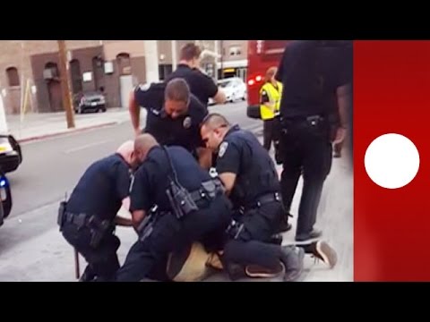 Youtube: "He's just a kid!" Onlookers horrified as 9 police arrest teen for 'jaywalking'