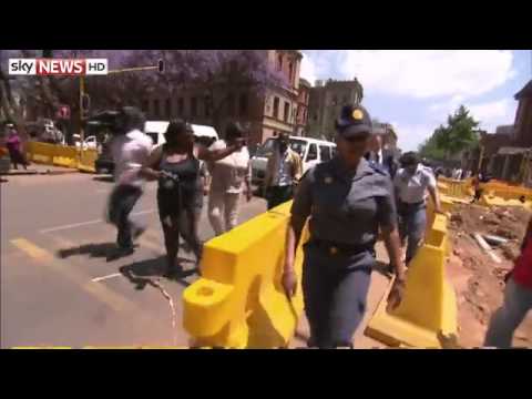 Youtube: Pistorius Lends A Hand To Cameraman Outside Court