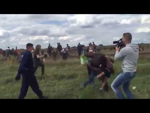 Youtube: VIDEO: Camerawoman for N1TV trips a refugee carrying a small child as he runs from police